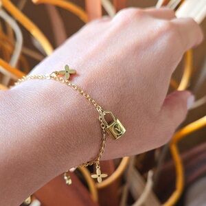 18K Gold Designer Charm Bracelet with Lock and Flower Accents